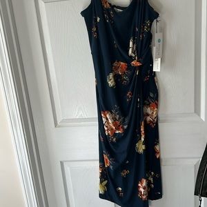 Floral midi dress with side slit and knot detail. Spaghetti strap with v-neck